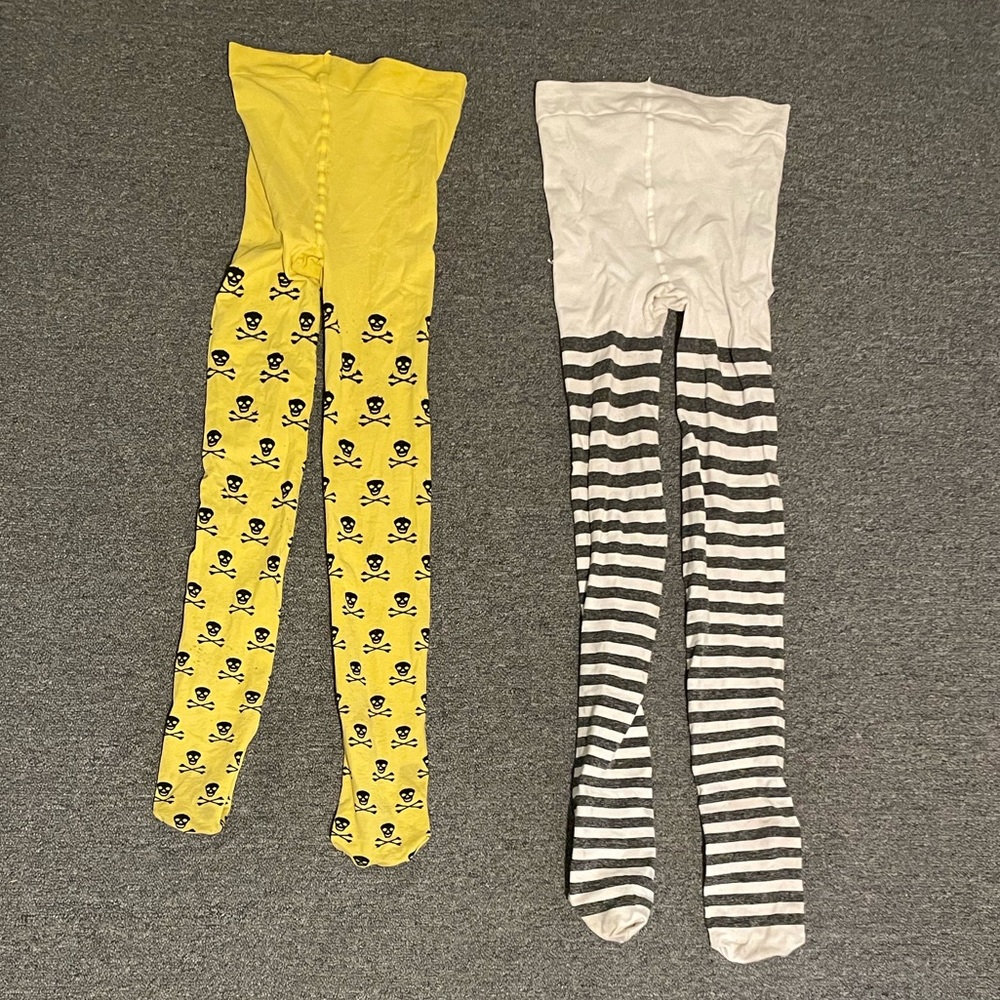 2 pairs Snag tights. Yellow w/ skulls and white/gray striped. Size F short